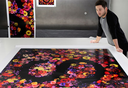 man standing next to print