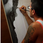 man drawing with pencil