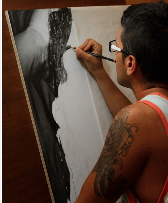 man drawing with pencil