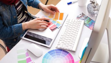 Young Handsome Graphic designer using graphics tablet to do his