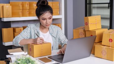 small-online-business-owner-woman-working-with-laptop-prepare-parcel-boxes-deliver-customer
