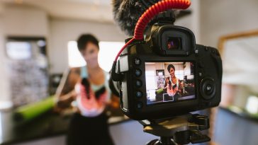 Social media influencer recording video for blog
