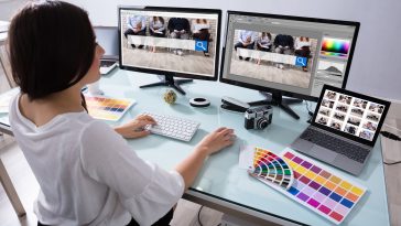 Female Designer Working On Multiple Computer