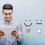 Customer Experience Concept, Happy Businessman holding digital Tablet with a checked box on Excellent Smiley Face Rating for a Satisfaction Survey