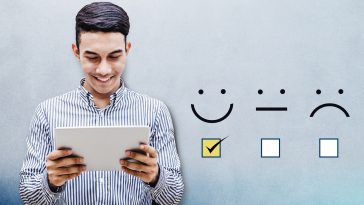 Customer Experience Concept, Happy Businessman holding digital Tablet with a checked box on Excellent Smiley Face Rating for a Satisfaction Survey